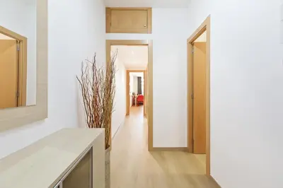 a hallway of a house with white walls and wooden floors at El balcón de Sagrada Familia in Barcelona