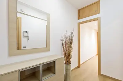 a mirror in a bathroom with a vase at El balcón de Sagrada Familia in Barcelona