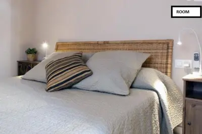 a bed with two pillows on top of it at Family apartment Plaza España in Barcelona