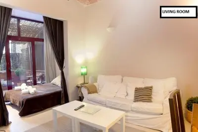 a living room with a white couch and a table at Family apartment Plaza España in Barcelona