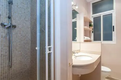 a bathroom with a sink and a toilet and a shower at Family apartment Plaza España 2 in Barcelona