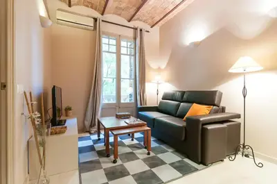 a living room with a couch and a table at Family apartment Plaza España 2 in Barcelona