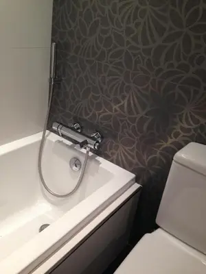 a bathroom with a tub and a sink and a toilet at The White Lilies in Pineda de Mar