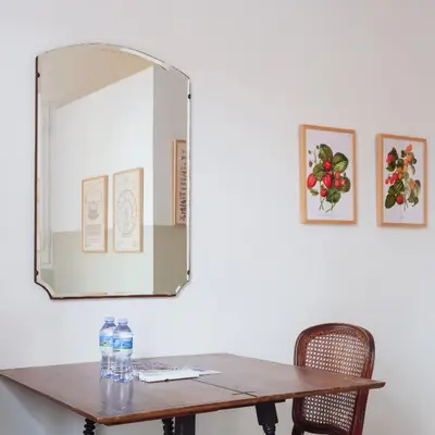 a mirror on a wall next to a table at Verdi 254 in Barcelona