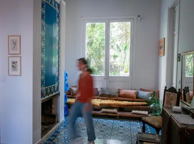 a man walking through a living room with a couch at Verdi 254 in Barcelona