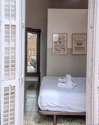 a bedroom with a bed with towels on it at Verdi 254 in Barcelona