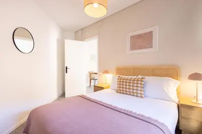 a bedroom with a large bed and a mirror at Stay U-nique Apartment Rossello II in Barcelona