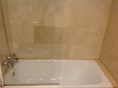 a white bath tub with a glass shower door at Apartment familiar in Barcelona