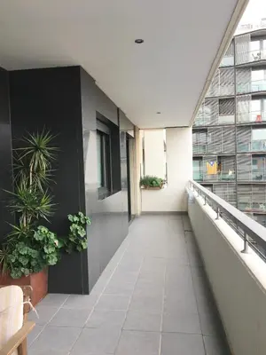 an empty hallway in an office building with plants at Apartment familiar in Barcelona