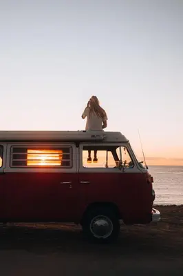 a person sitting on the top of a van at Retro VW Kombi T2 Campervan in Hospitalet de Llobregat