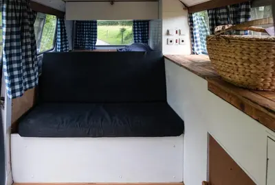 a seat in the kitchen of a tiny house at Retro VW Kombi T2 Campervan in Hospitalet de Llobregat