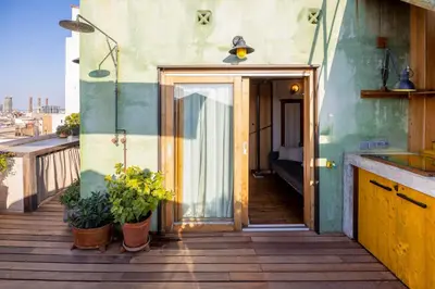 a balcony with potted plants on a building at Apartment with Terrace Views of BCN in Barcelona