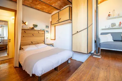 a bedroom with a bed and a blue chair at Apartment with Terrace Views of BCN in Barcelona