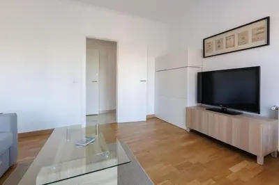 a living room with a flat screen tv on a table at Housalia Casa del Mar en Vila Olímpica in Barcelona