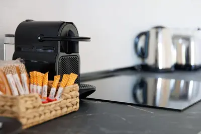 a basket of corn on a counter next to a toaster at Housalia Casa del Mar en Vila Olímpica in Barcelona
