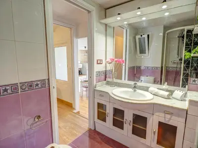 a bathroom with a sink and a mirror at Carmen Apartment by Hello Homes Sitges in Sitges