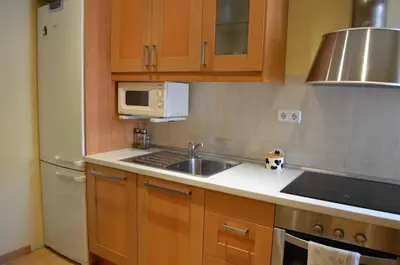 a kitchen with a sink and a microwave at Apartment Bed&BCN Sant Andreu II in Barcelona