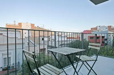 a table and two chairs sitting on a balcony at YOUR HOME- Apartment Camp Nou 2a in Hospitalet de Llobregat