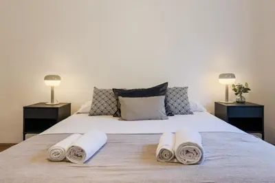 a bedroom with a large bed with towels on it at Plaza España 238 in Barcelona