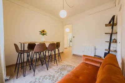 a living room with a couch and a table and chairs at Plaza España 238 in Barcelona