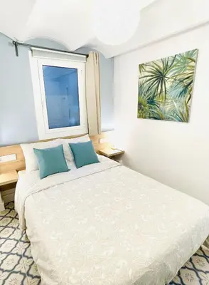 a bedroom with a large bed and a window at Lazy Donkey Sagrada Familia in Barcelona