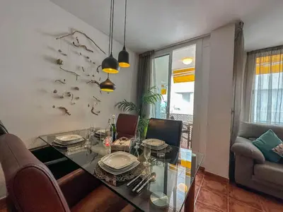 a dining room with a glass table and chairs at Sira House by Hello Homes Sitges in Sitges