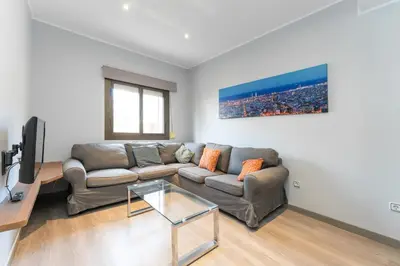 a living room with a couch and a tv at La Sagrera House in Barcelona