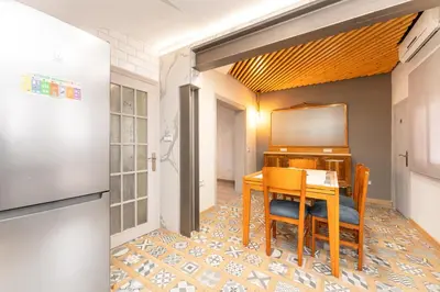 a dining room with a table and a piano at La Sagrera House in Barcelona