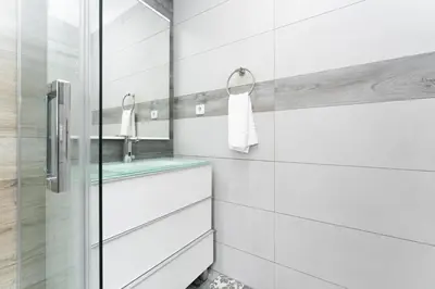a white bathroom with a sink and a mirror at La Sagrera House in Barcelona