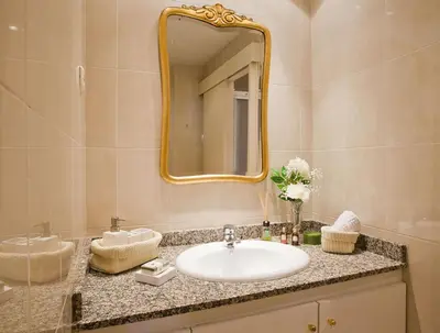 a bathroom with a sink and a mirror at Apartment Eixample Comfort in Barcelona