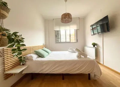 a bedroom with a large bed in a room at Playa, piscina, parking GENIAL in Cubelles