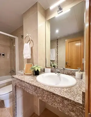 a bathroom with a sink and a toilet at Playa, piscina, parking GENIAL in Cubelles
