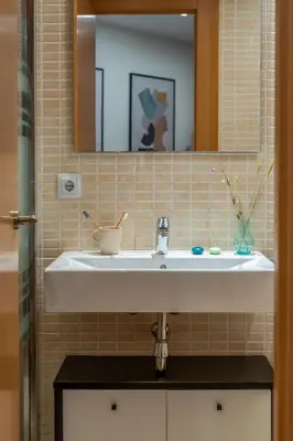 a bathroom with a white sink and a mirror at Canela Homes BARCELONA FLORIDABLANCA in Barcelona