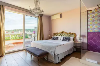 a bedroom with a large bed and a large window at Canela Homes BARCELONA SEPULVEDA in Barcelona