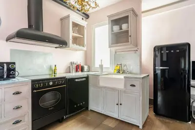 a kitchen with black appliances and a black refrigerator at Canela Homes BARCELONA SEPULVEDA in Barcelona