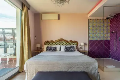 a bedroom with a bed and a window and a tub at Canela Homes BARCELONA SEPULVEDA in Barcelona