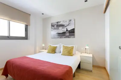 a bedroom with a bed and two night stands at Durlet Rambla Mar Apartments in Barcelona