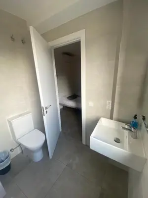 a bathroom with a white toilet and a sink at Hostal La Masia in Manresa
