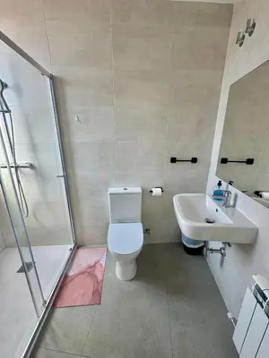 a bathroom with a shower and a toilet and a sink at Hostal La Masia in Manresa