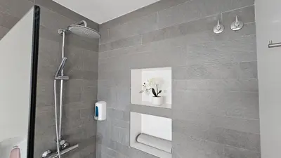a bathroom with a shower with a vase of flowers at Cal Sidru Castellolí in Castellolí