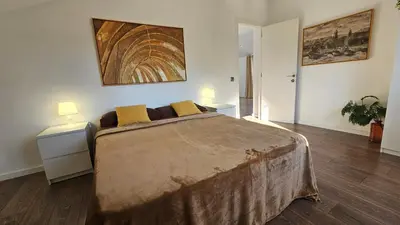 a bedroom with a large bed with two night stands at Cal Sidru Castellolí in Castellolí