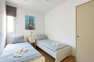 a bedroom with two beds and a mirror at Ma Bright apartment next to Parc de Montjuïc in Barcelona