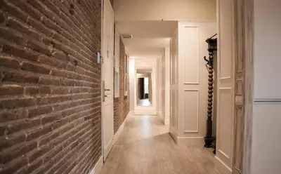 a hallway with a brick wall and a hallway with a door at Enjoybcn Miro Apartments in Barcelona