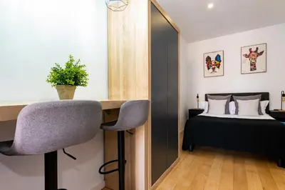 a bedroom with a desk and a bed and a mirror at R&B Mila in Barcelona