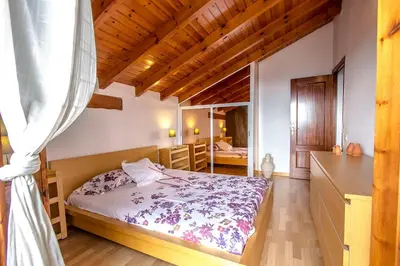 a bedroom with a bed in a room at Swiss style villa near Barcelona 10min to beach in Sant Cebrià de Vallalta