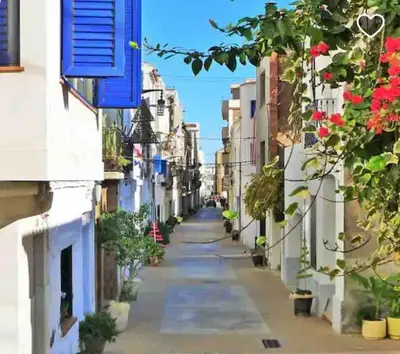 an empty street in a city with flowering plants at Apartamento Sol Terraza in Montgat
