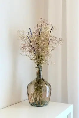 a vase filled with flowers sitting on a table at Barcelona Amelie Apartment in Hospitalet de Llobregat
