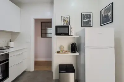 a kitchen with a white refrigerator and a microwave at Barcelona Amelie Apartment in Hospitalet de Llobregat