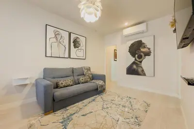 a living room with a brown couch in a room at Barcelona Aura Apartments in Hospitalet de Llobregat