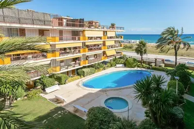 an aerial view of a resort with a swimming pool and the ocean at Canela Homes COSTA CALMA in Castelldefels